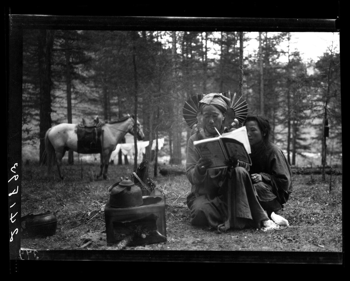 Mongolian Woman reading Harpers magazine in 1919.