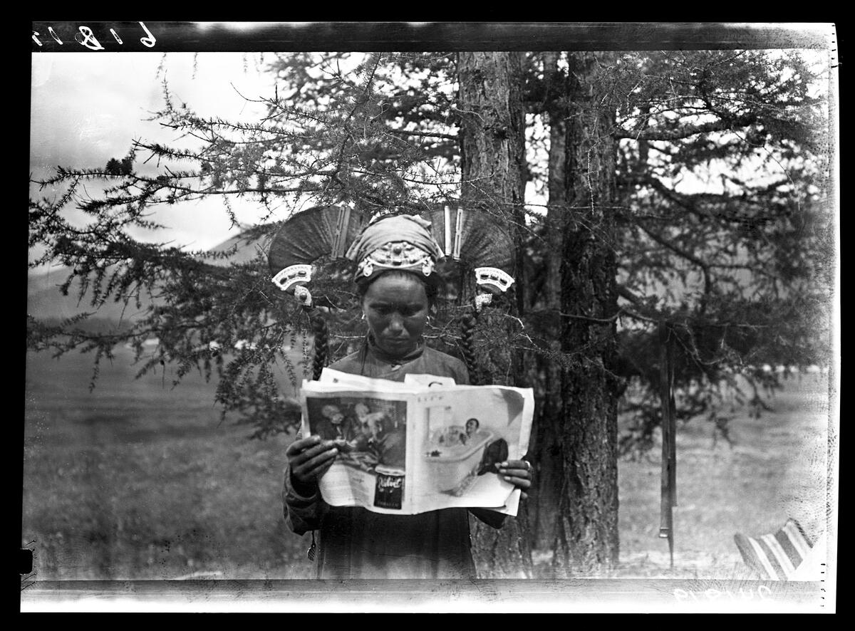 Mongolian Woman reading Life magazine in 1919.